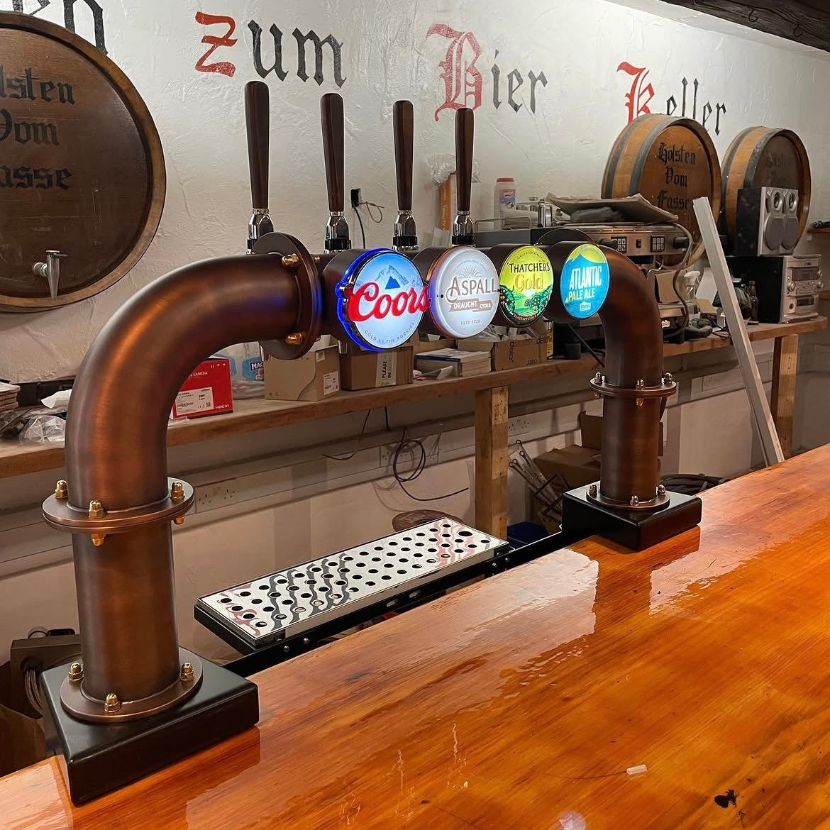 Copper T-bar with branded fonts including Coors and Aspall