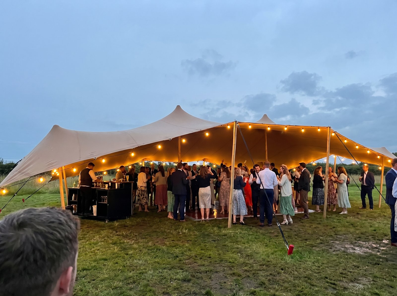 Stretch tent lit up at a wedding