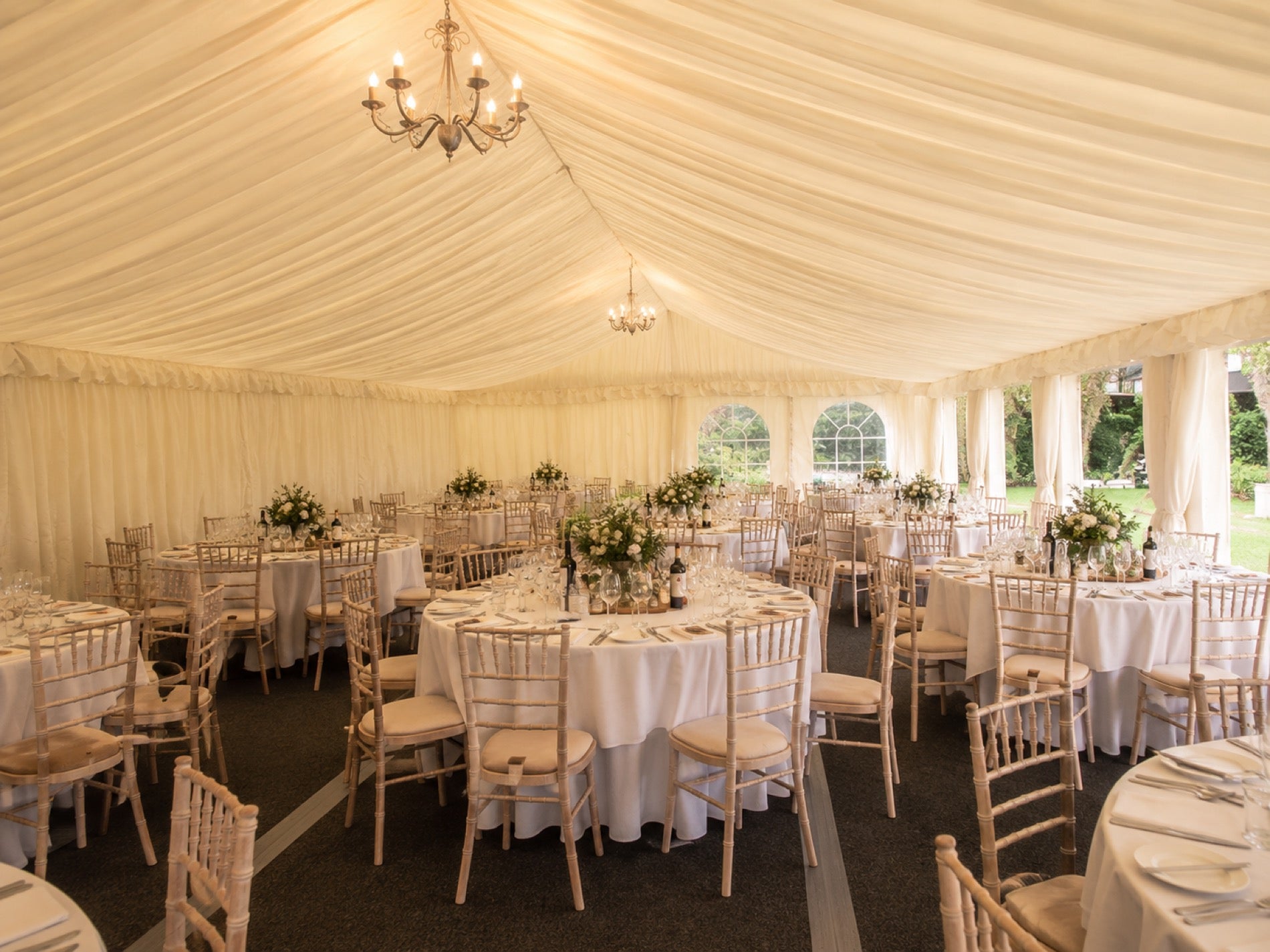 The Classic interior with cream lining, chandeliers and chiavari chairs